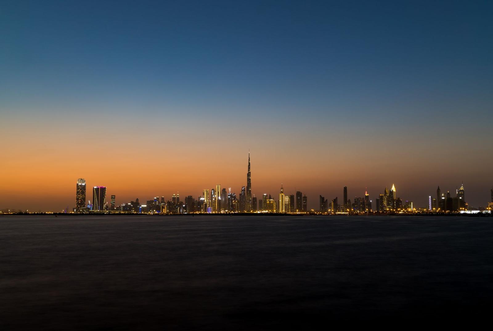 Outstanding Cityscape of Dubai Across Sea at Dusk